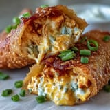 Golden, crunchy egg rolls stuffed with creamy, spicy Buffalo chicken dip and melted cheddar cheese.