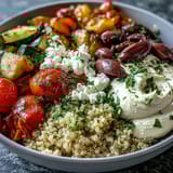 This nourishing Mediterranean Buddha Bowl showcases creamy hummus, tangy feta, and a colorful mix of roasted veggies.
