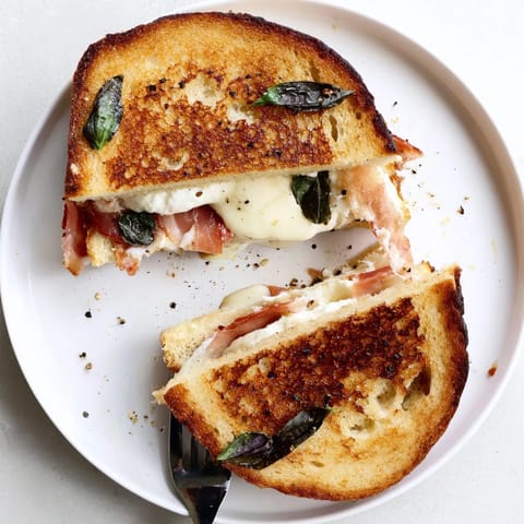 Crispy Prosciutto & Burrata Grilled Cheese on toasted bread, featuring melted cheese and savory Italian-inspired flavors.