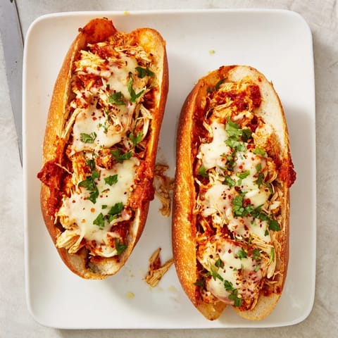 Golden-brown Chicken Parm Stuffed Garlic Bread boats overflowing with gooey mozzarella and Parmesan cheese.  