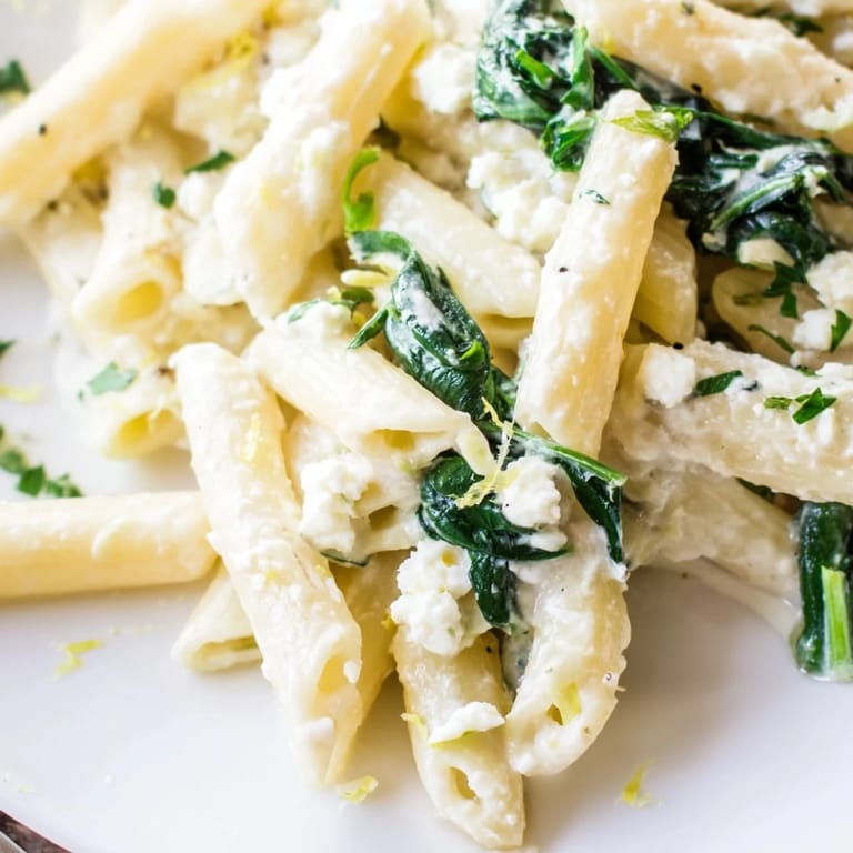 Hearty Creamy Feta Spinach Pasta served on a rustic table, ready to be enjoyed for dinner.