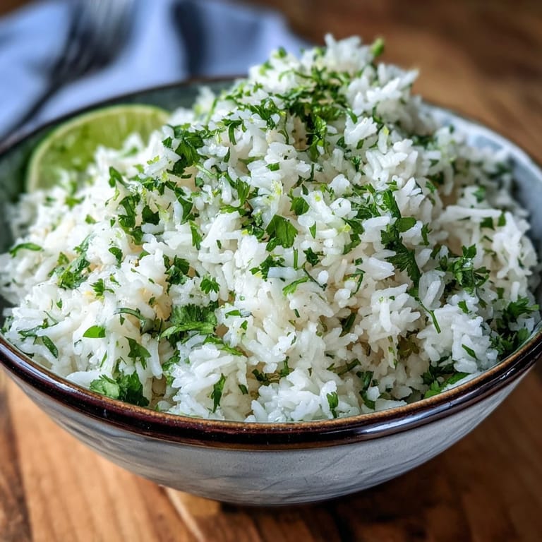 Vibrant cilantro lime rice glistening with lime juice, a perfect Mexican side dish.