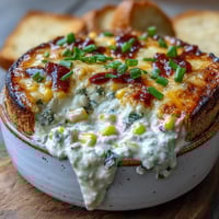 Creamy Crack Corn Dip with cheddar and jalapeños served warm in a bowl with tortilla chips.