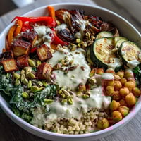 Vibrant Mediterranean Buddha Bowl Meal Prep shows roasted eggplant, kale, and peppers over bulgur, finished with creamy tahini dressing for a healthy lunch.