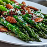 Bright lemon butter asparagus with crunchy toasted almonds, a fresh and vibrant spring side dish.  